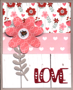 A decorative card with floral and heart patterns, featuring a pink flower.